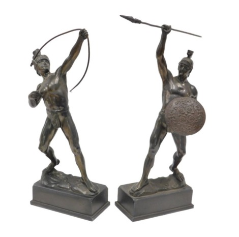 A pair of bronzed spelter figures, each modelled as a Roman warrior in grand tour style, one holding a spear, the other a bow, each on a rectangular base, 38cm high.