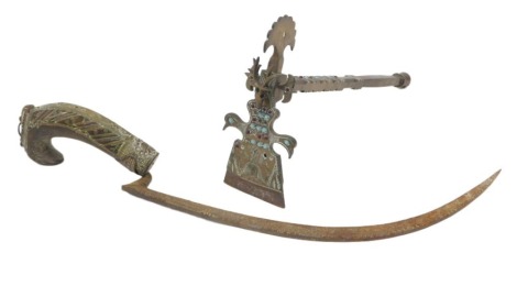 Two Persian rug making implements, to include a scraping device decorated with birds and inset with blue and red cabochon, mounted with a stag, 29cm long, and a curved knife with engraved iron blade, the wooden handle inset in copper and silver coloured m