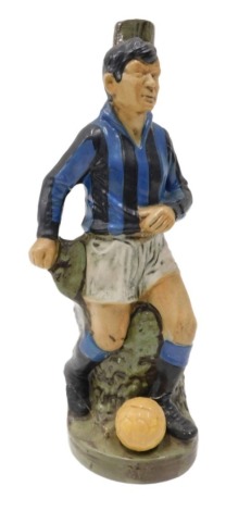 A novelty Italian Curaco decanter, modelled in the form of a football player wearing blue and black stripes, possibly Inter Milan, with contents, 30cm high.