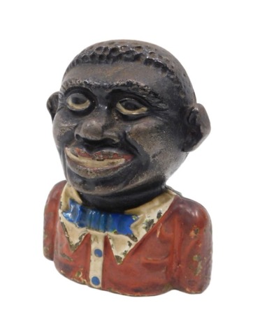 A cast money box modelled as a young man, painted in red and black.