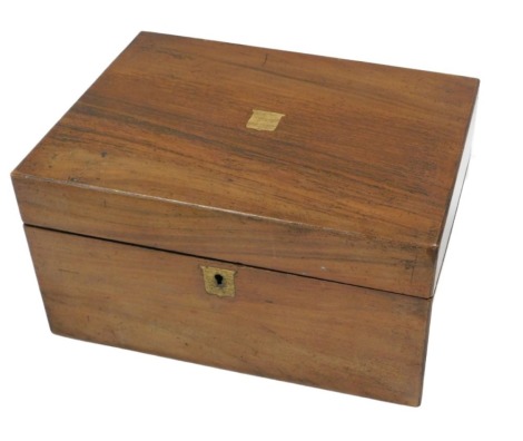 A late Victorian walnut writing box, the hinged lid with a vacant brass shield shaped cartouche, enclosing a fitted interior, 30cm wide. (AF)