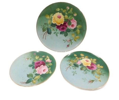 A pair of late 19thC Staffordshire wall plaques, each decorated with roses and leaves, 34cm diameter, and another larger, 40cm diameter, bearing name G Bourne.