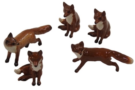 A collection of five small Beswick foxes, in various poses, 7.5cm high, etc.