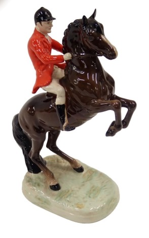 A Beswick ceramic model of a huntsman, on rearing brown horse, 25cm high.