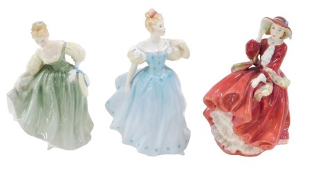 Three Royal Doulton porcelain figurines, Top O'the Hill, Fair Lady, and Enchantment.