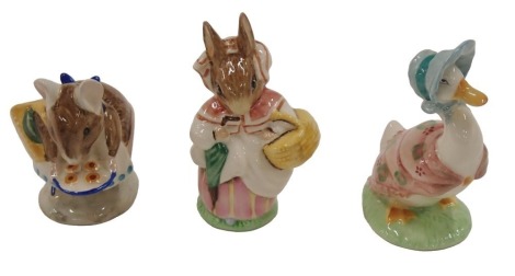 Three Beswick Beatrix Potter figures, Appley Dappley, Jemima Puddleduck, and Mrs Rabbit.