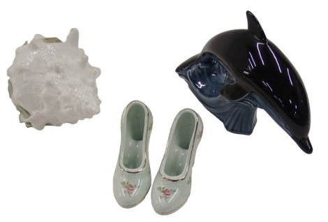 A Poole pottery dolphin, a pair of ceramic shoes, and a St Michael porcelain flower encrusted shell. (4)