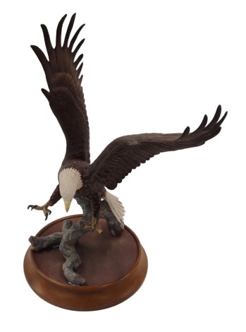 A Franklin Mint American Majesty figure of an eagle, on ceramic base, after Ronald Van Reuykebelt, 37cm high.