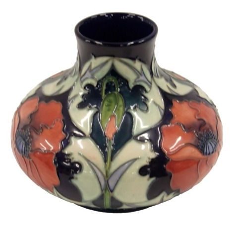 A Moorcroft ceramic squat baluster shaped vase, decorated with poppies, on a blue and green ground, copyright 1996, impressed marks to underside.