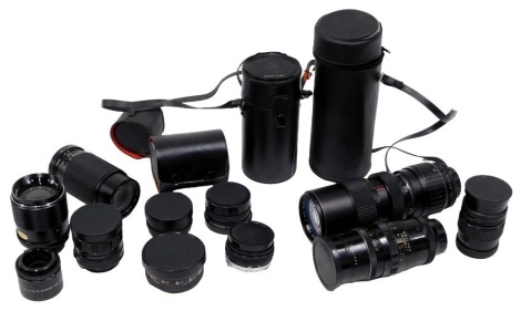 A group of camera lenses, comprising a Pentagon 4/200, Access SQ number 89532 lens, a Photax Paragon 583318, Olympus 50mm camera, Solidure tele converter, Mirage multi photo zoom 1-3.5, Toko video wide angle lens, Solidure wide auto 1-2.8 lens, Yashikor a