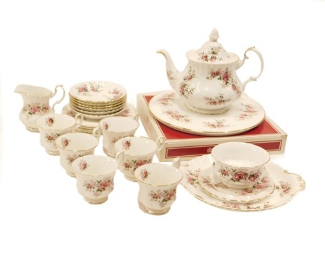 A Royal Albert Lavender Rose pattern part tea service, comprising cake plates, teapot, milk jug, sugar bowl, six cups and saucers, six side plates, cake plate, and a teapot stand.