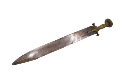 A 19thC Indian sword, with hammered and engraved brass handle, on a shaped blade, 57cm long.