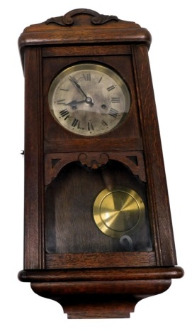 An early 20thC oak cased wall clock, with silvered dial, 60cm high.