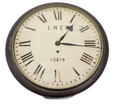 An LNER wall clock, on painted white dial with Roman numerals, numbered 10219, fusee movement, 35cm diameter, with pendulum.