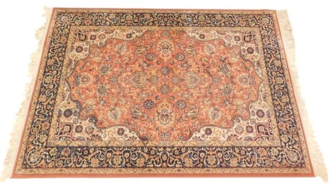 A Belgian machine woven Keshan super Persian style rug, on a pink ground, one wide, two narrow borders, 213cm x 141cm.