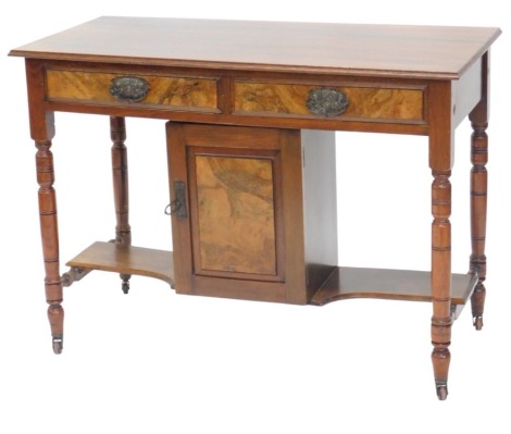 A late Victorian walnut side table, the later mahogany top with a moulded edge above two frieze drawers and a door, flanked by recesses, on turned legs with castors, 105cm wide.