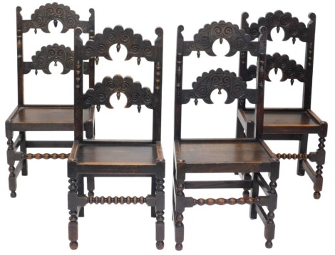 A set of four Yorkshire style oak dining chairs, each with a carved back, a solid seat on turned supports.