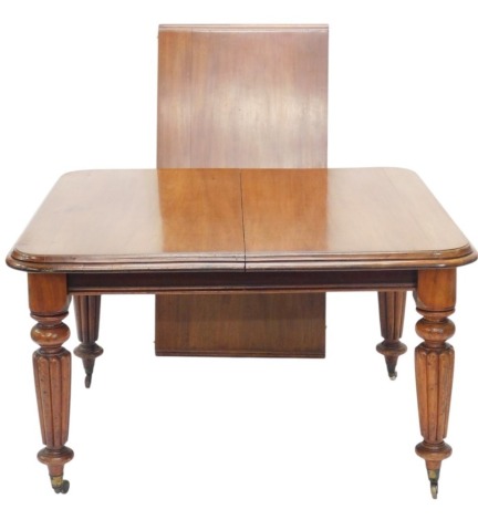 A Victorian mahogany extending dining table, the rectangular top with a mounded edge, on turned and fluted legs with casters, one loose leaf, 71cm high,182cm long, 181cm wide.