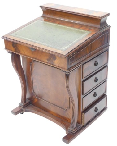 A reproduction mahogany Davenport, the top with a hinged pen compartment and a hinged lid, with green leather insert enclosing a vacant interior, with four drawers apposing four false drawers, on reeded sabre shaped supports and castors, 62cm wide.