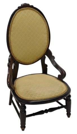 A Victorian stained beech nursing chair, with an oval padded back and seat, on turned legs, with stretchers.