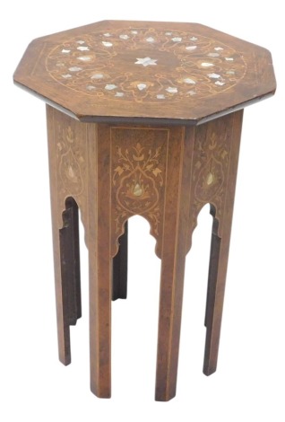 An early 20thC rosewood and marquetry Moorish style table, the octagonal top inlaid in mother of pearl, on faceted legs, with arches, 61cm high, 45cm wide.