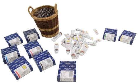 A quantity of Windsor and Newton oil paints, some boxed, others within a basket.