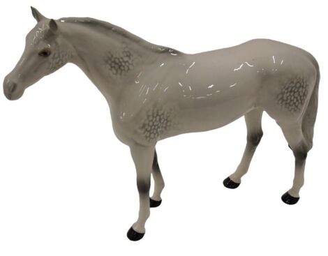 A large Beswick white palomino ceramic horse, 28cm high.