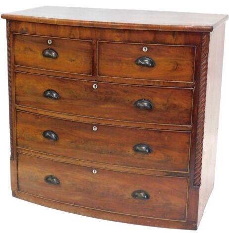 A Victorian mahogany bow fronted chest of drawers, with mother of pearl escutcheons to the two short and three long drawers, with later solid metal handles, flanked by spirally turned pilasters, 101cm wide. (AF)