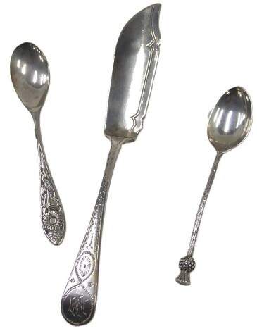 A Mackay and Chisholm Victorian silver fish knife, of beaded top bearing the initials MF, a silver thistle topped teaspoon, 1.92oz, and a silver plated teaspoon. (3)