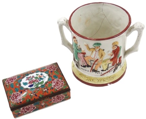 A 19thC Staffordshire frog loving cup, with raised relief figures, on chairs, painted border, and frog centre, 14cm high, and a continental enamel trinket box. (2, AF)