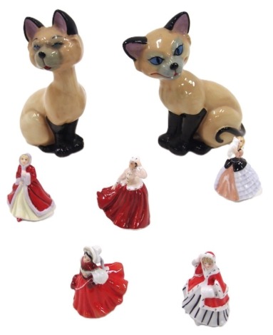 Five Royal Doulton miniatures, comprising Gale, Susan, Noel, Festive Joy, and Susan, and two Wade cat figures, the Doulton boxed. (7)