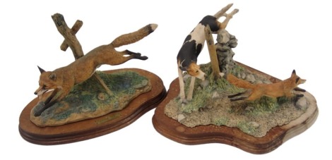 Two Border Fine Arts figure groups, comprising fox and spaniel, 19cm high, and the Leicestershire fox, 22cm high, each on wooden base. (2, AF)