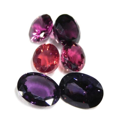 Six loose gemstones, comprising a rose garnet, approx 3.33cts, a red spinel, approx 3.72ct, a red garnet, approx 3.77ct, a purple spinel, approx 4.46ct, a round brilliant cut purple spinel, approx 4.97ct, and an oval purple spinel approx 4.93ct.