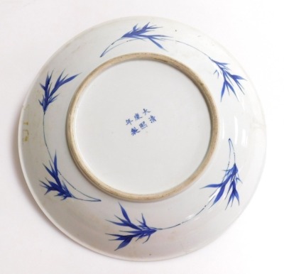 A 19thC Qing dynasty Chinese porcelain charger, decorated in blue and white with various figures in a landscape and a diaper work border, six character Kangxi mark to base, in underglaze blue, 37cm diameter. (AF) - 3