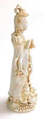 A 20thC Chinese porcelain figure of Guanyin standing on a lotus base, with a matte orange residue to the crevices, 31cm high. - 4