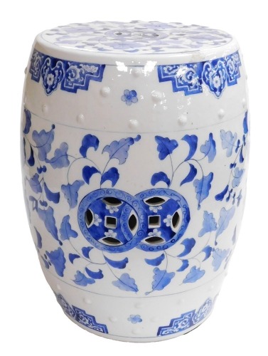 A 20thC Chinese blue and white porcelain barrel seat, of cylindrical form, decorated with raised studding and with scrolling leaf design, 47cm high.