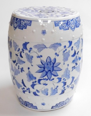 A 20thC Chinese blue and white porcelain barrel seat, of cylindrical form, decorated with raised studding and with scrolling leaf design, 47cm high. - 2