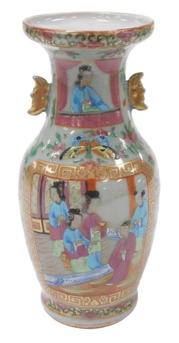 A 19thC Qing dynasty Chinese porcelain baluster vase, with a celadon glaze enriched in coloured enamels with figures at court, butterflies, flowers, etc., with moon shape lug handles, 24cm high. (AF)