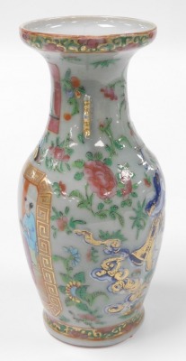 A 19thC Qing dynasty Chinese porcelain baluster vase, with a celadon glaze enriched in coloured enamels with figures at court, butterflies, flowers, etc., with moon shape lug handles, 24cm high. (AF) - 2