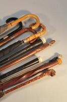 A collection of walking sticks and umbrellas