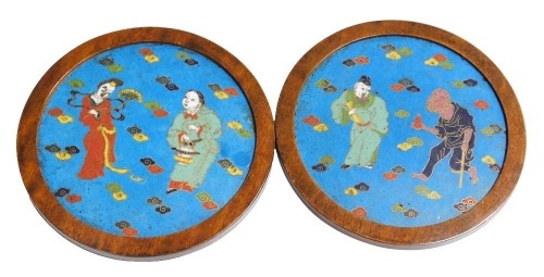 A pair of 17th/18thC Chinese enamel plaques, each with figures of men and women within stylized clouds, in late 19thC rosewood frames, 18cm diameter. Provenance: The John and Margaret Rankine Collection. Accompanied by a copy of the purchaser invoice fro