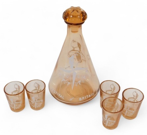 A Festival of Britain 1951 orange tinted glass decanter, of cylindrical, tapering from, with stopper, 19cm high, together with five liqueur glasses, 5cm high.