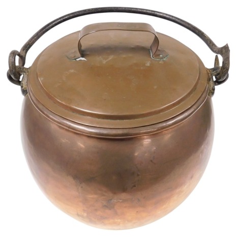 A 19thC copper cauldron, with lid, and cast iron swing handle, 43cm wide.