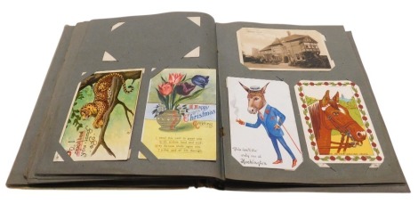 Deltiology postcards, Edwardian and later topographical, humorous, military, and sentimental postcards, in one album.