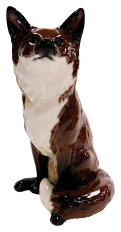 A Beswick pottery fireside figure, modelled as a seated fox, impressed marks and numbered 2348, 31cm high.