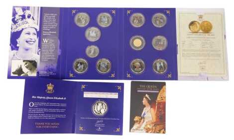 A group of Queen Elizabeth commemoratives, comprising The Commemorative Souvenir Postcards, issued by The Telegraph, a silver one crown, issued by Gibraltar 2002, in a presentation pack, and the Her Majesty Forever Remembered Coin Set, including a 9ct gol