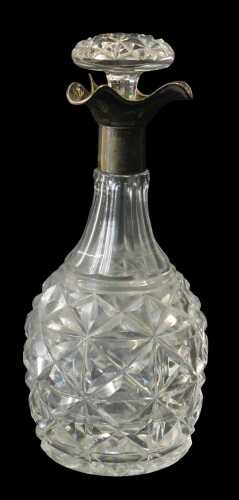 A George V cut glass and silver mounted decanter, of faceted bottle form, with a triform silver collar, Walter & Charles Sissons, Sheffield 1925, 27cm high.