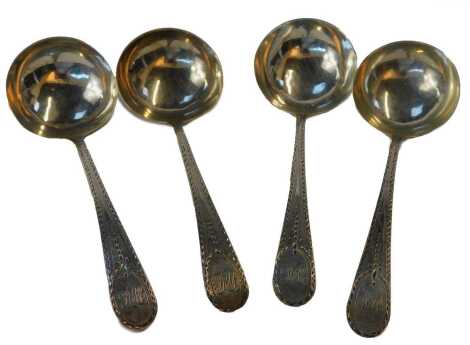 Four George III silver Old English pattern sauce ladles, each bright cut decorated and monogrammed, London 1784, 1.87oz.