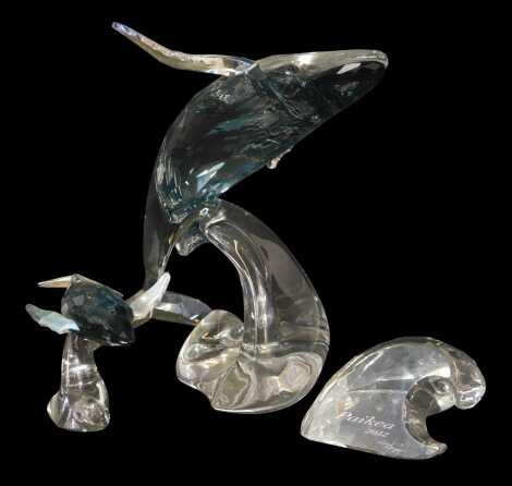 A Swarovski crystal 2012 edition Paikea whale, 15.5cm high, with name plaque, together with a calf riding wave, 7cm high, with certificates of authenticity, boxed.