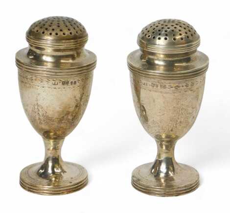 A pair of Victorian silver pepperettes, each of urn form, with engraved decoration of bows and swags, Frederick Brasted, London 1877, 5.36oz, 10cm high.